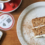 A piece of cake sitting next to App8's contactless dining tools.